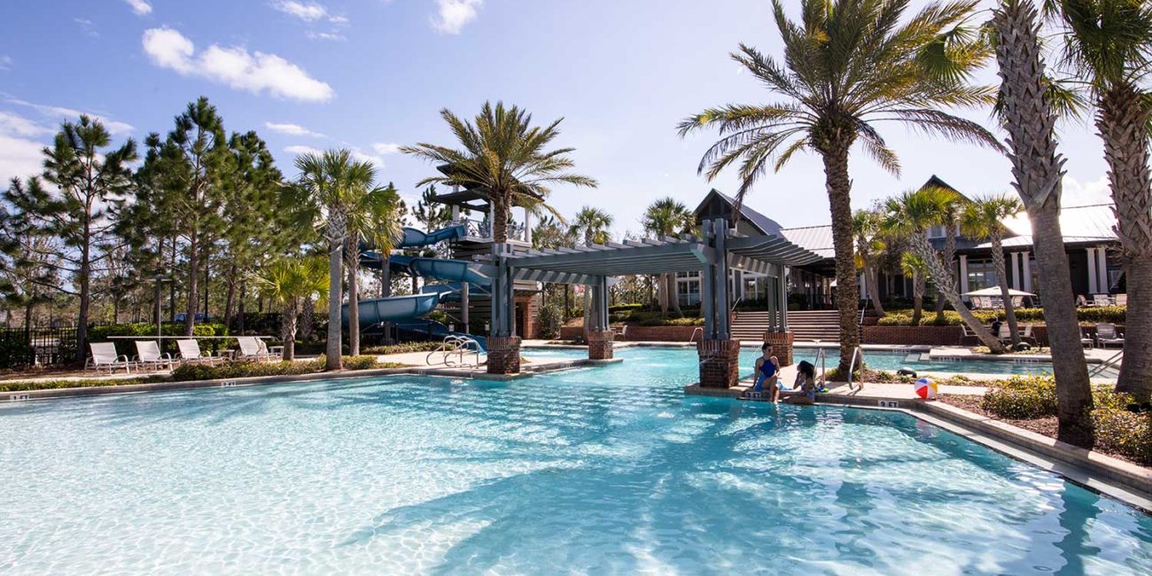 WaterSong clubhouse pool with swimmers relaxing in the shade